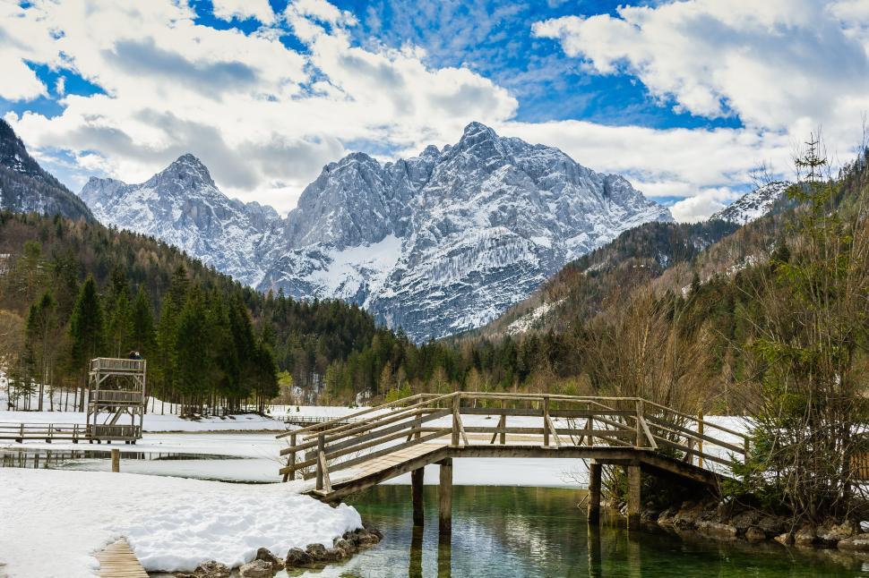 Free Image of Snow-covered mountain and wooden bridge 