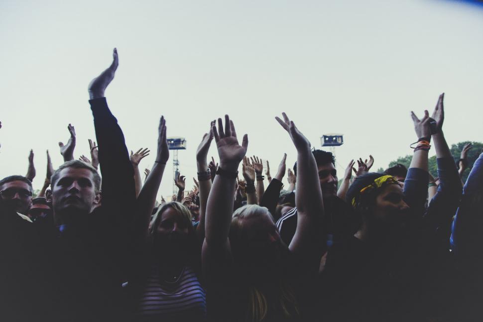 Free Image of Concert crowd with raised hands enjoying the music 