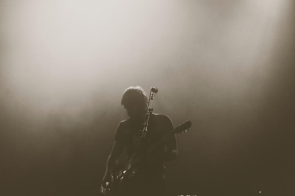 Free Image of Silhouette of a guitarist on stage 