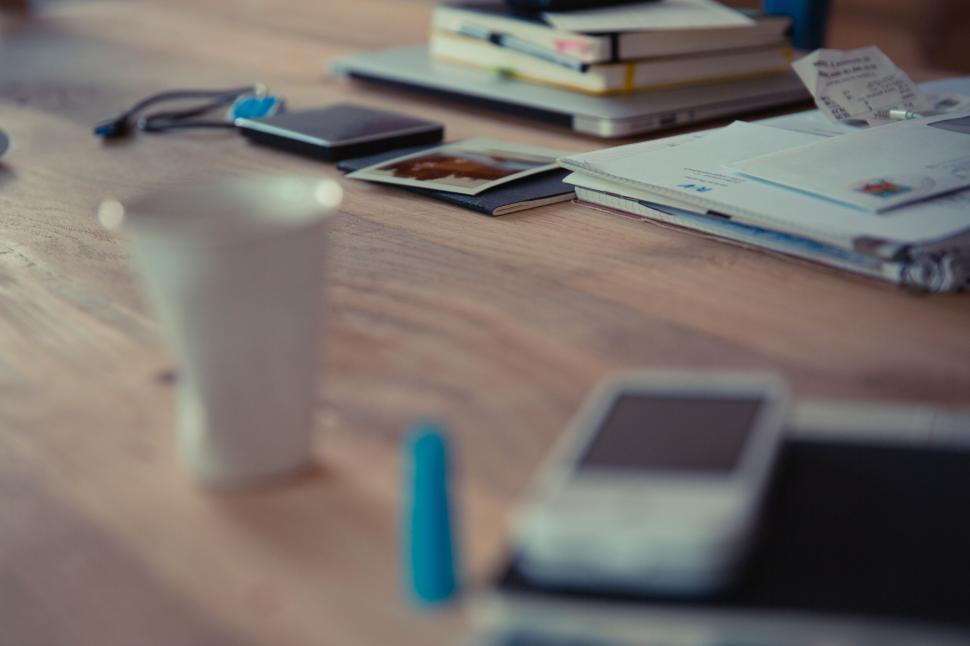 Free Image of Blurry office desk with personal items 