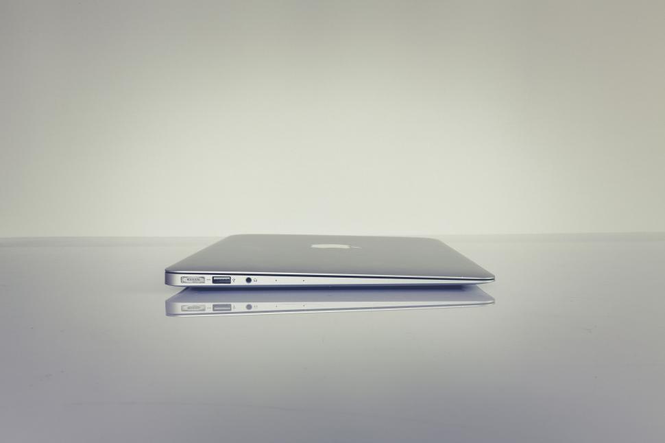 Free Image of Minimalist shot of a closed MacBook against backdrop 