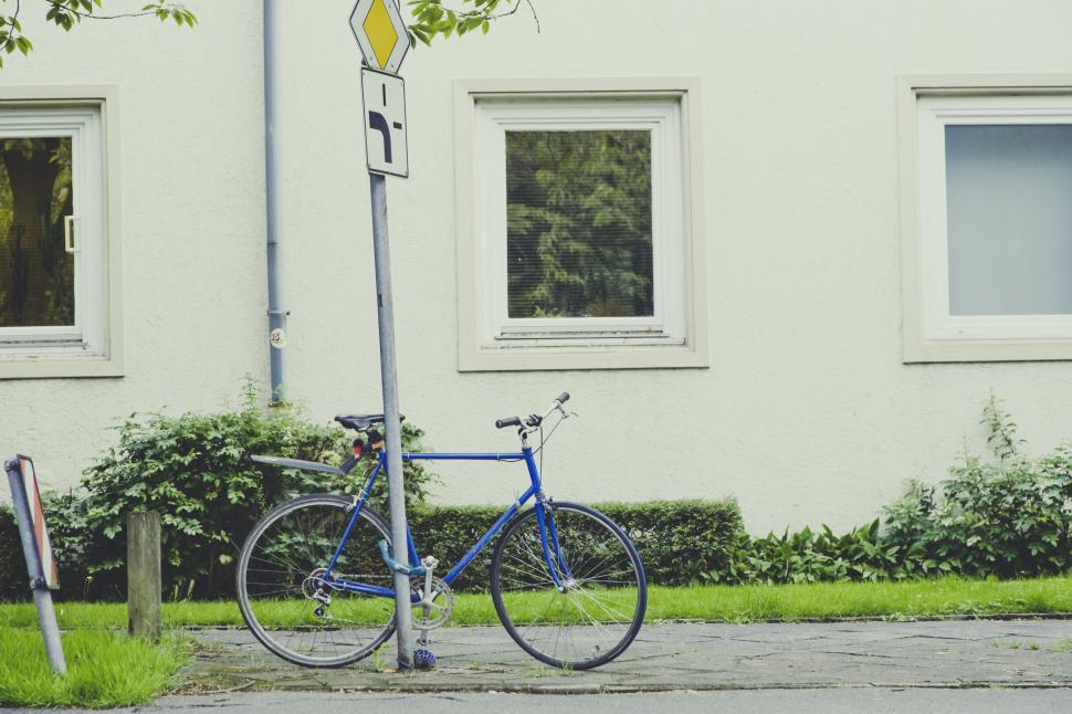 Free Image of Bicycle leaned against street signs 