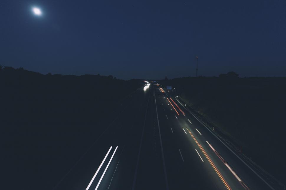 Free Image of Night highway with light trails under moon 