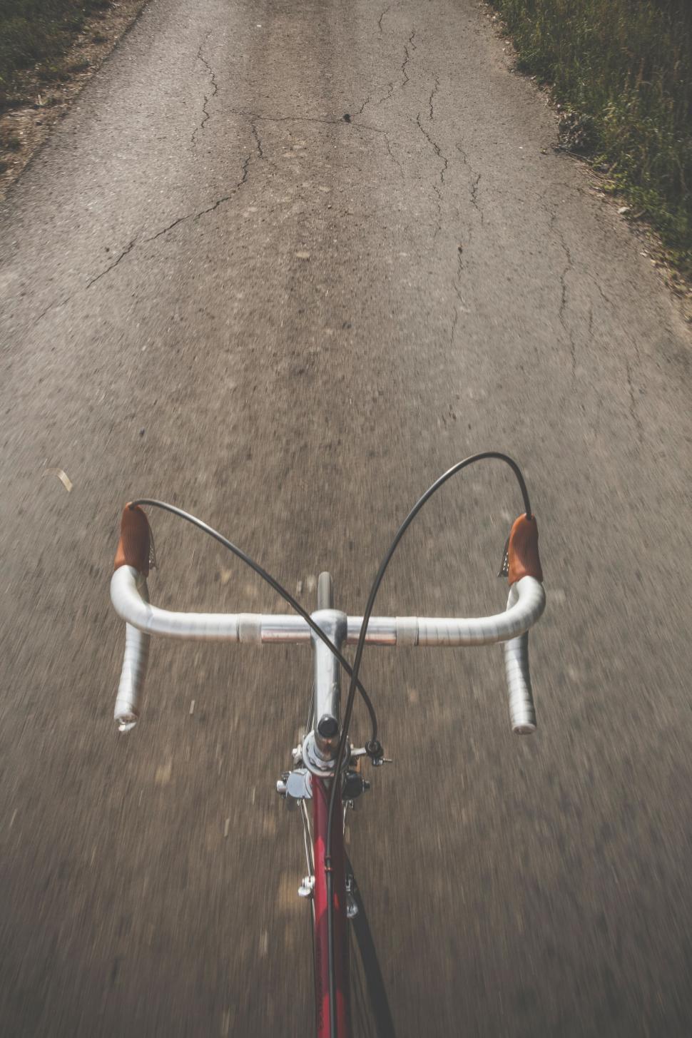 Free Image of POV of bike riding on a country road 