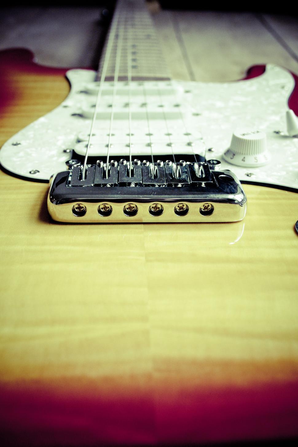 Free Image of Close-up of an electric guitar on wooden surface 
