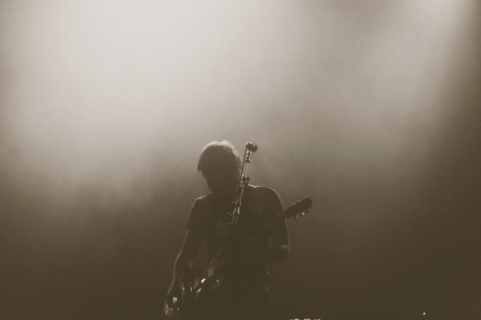 Free Image of Silhouette of a guitar player on stage 