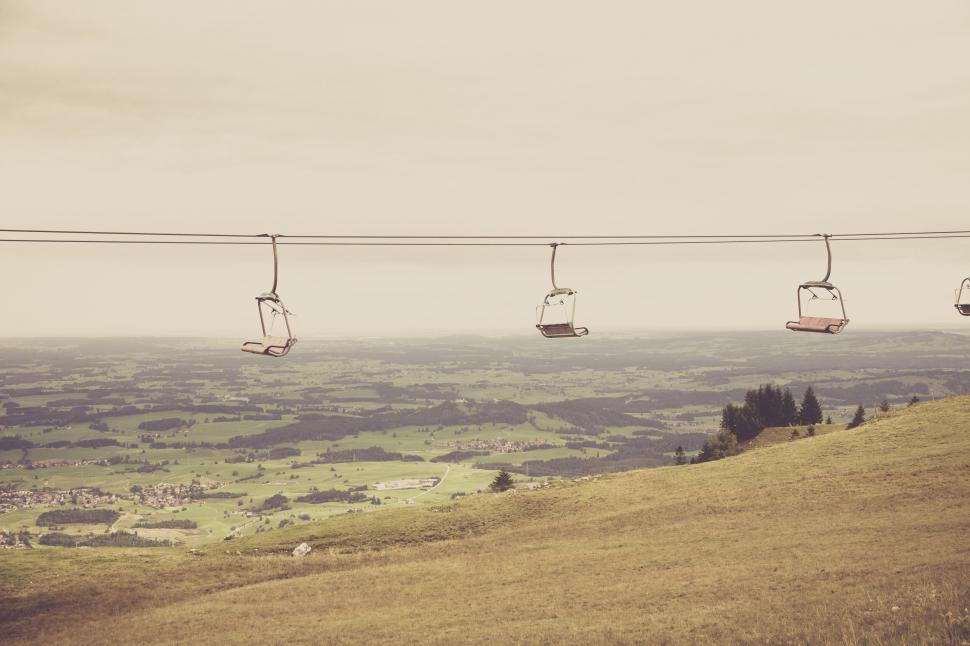 Free Image of Empty chairlifts over scenic mountain landscape 