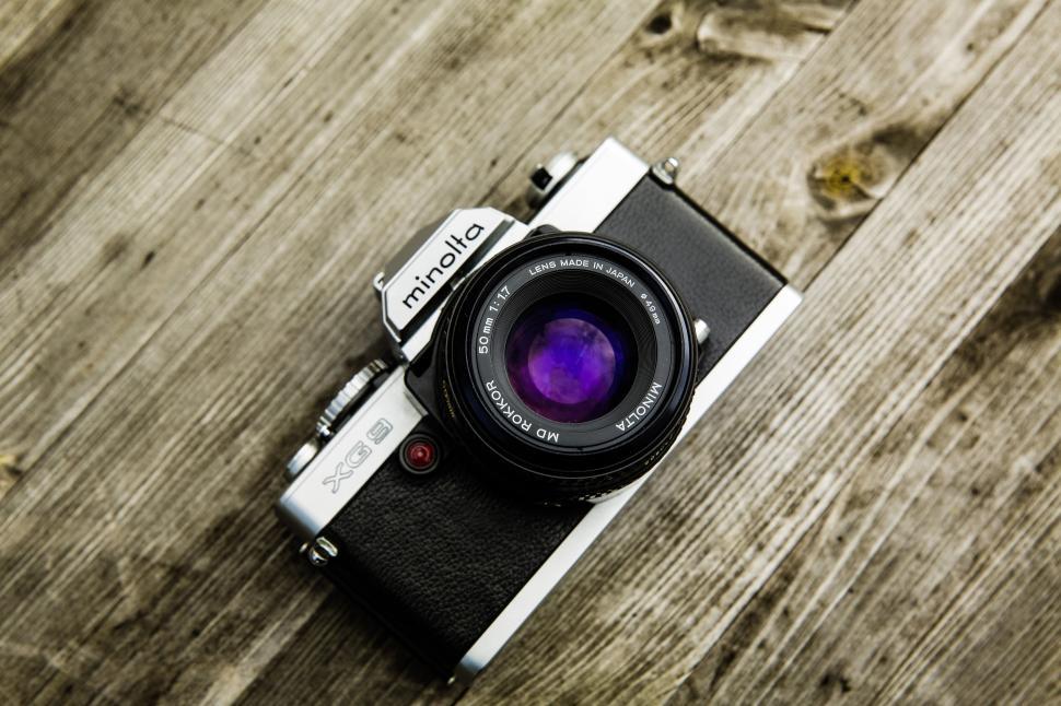 Free Image of Vintage Minolta camera on wooden surface 