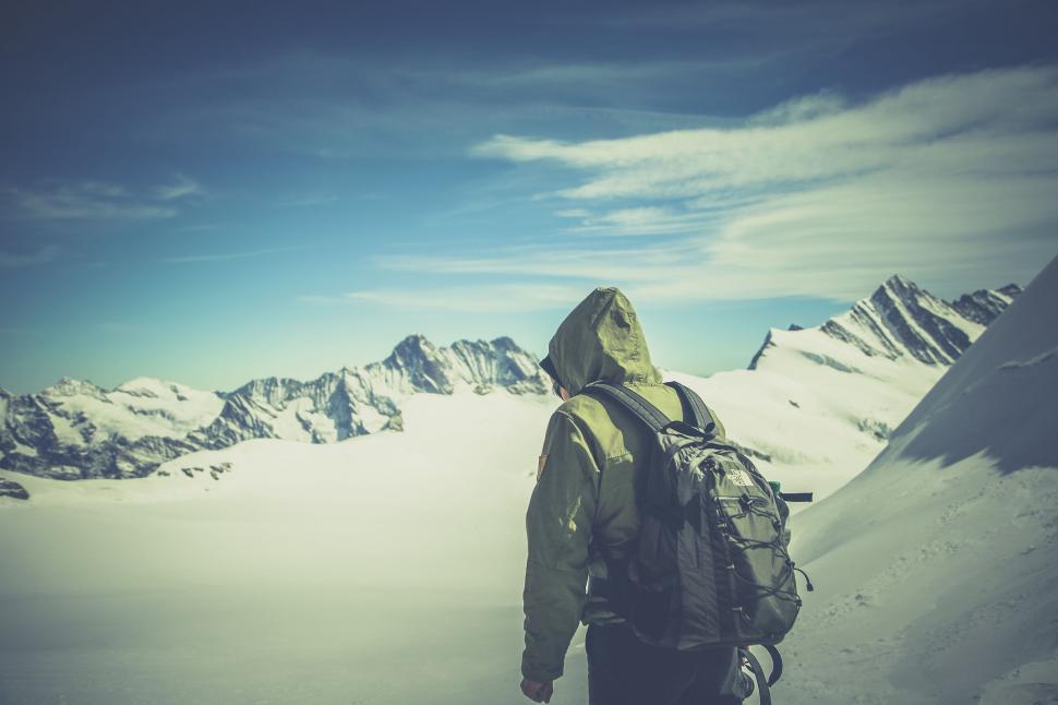 Free Image of Back view of a hiker in the snowy mountains 