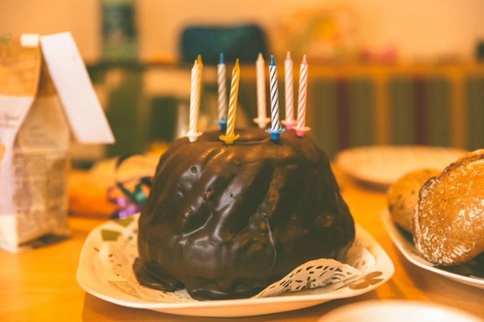 Free Image of Chocolate birthday cake with lit candles 