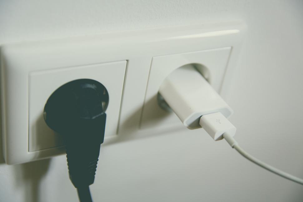 Free Image of Electrical plug inserted into a white socket 