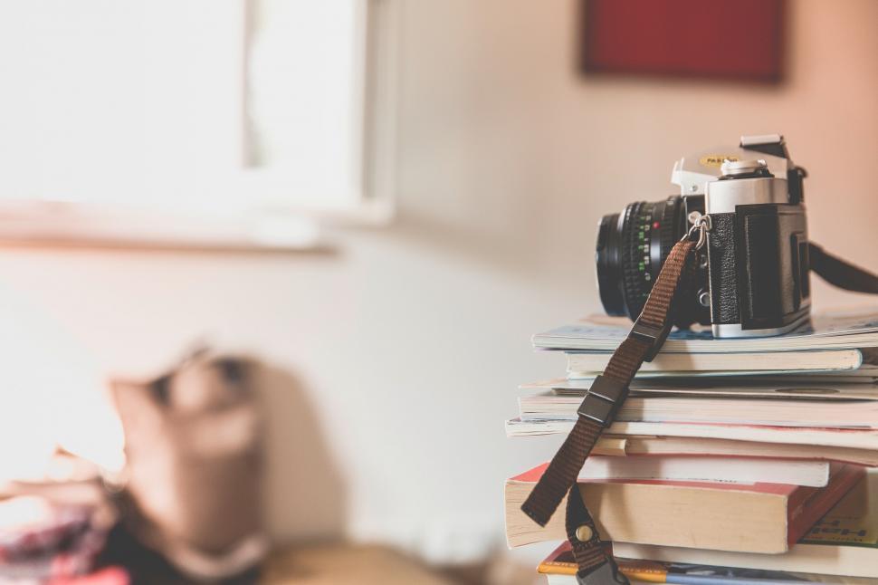 Free Image of Vintage camera atop a pile of books 