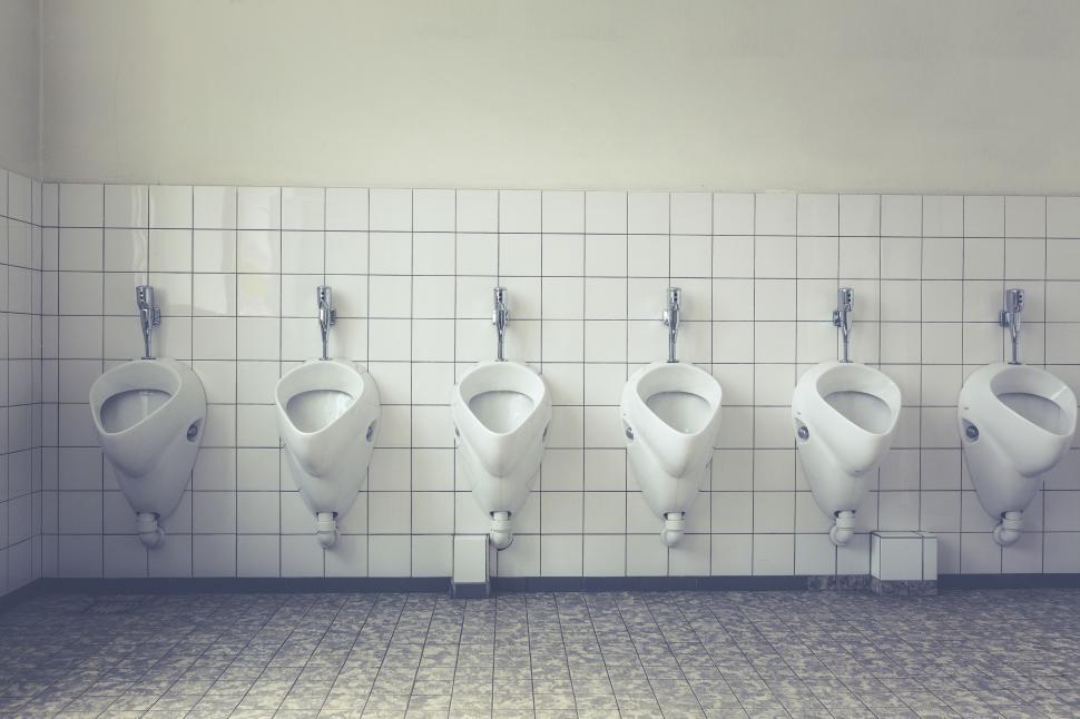 Free Image of Public bathroom with row of urinals on white tiles 