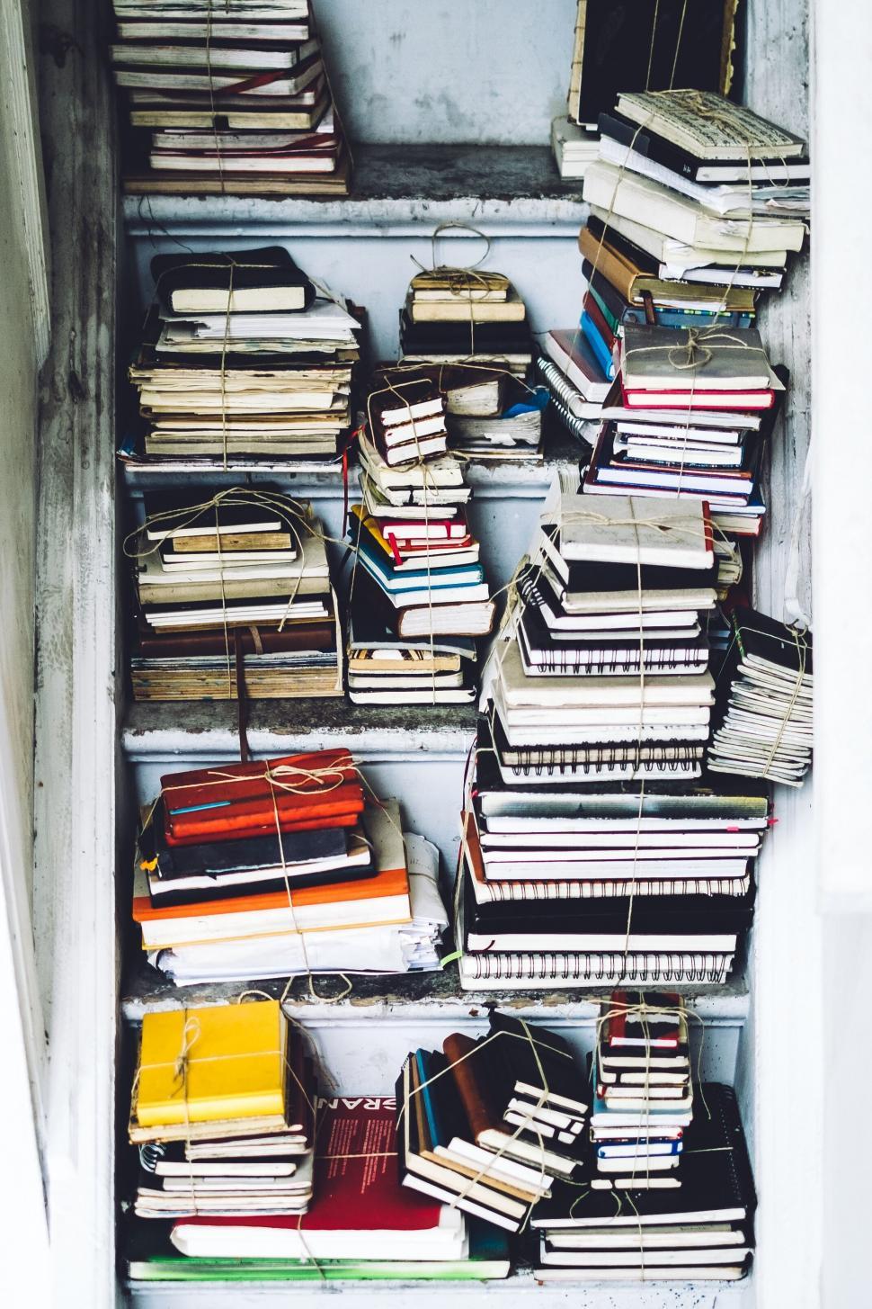 Free Image of Stacked books in an unorganized shelf 