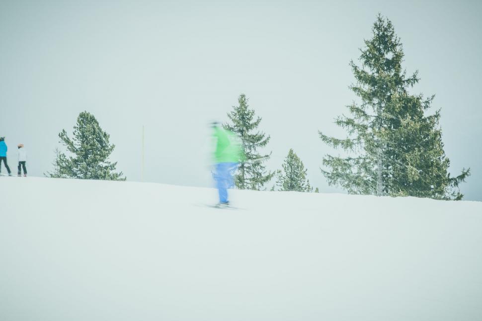 Free Image of Blurred skier in motion on snowy slope 