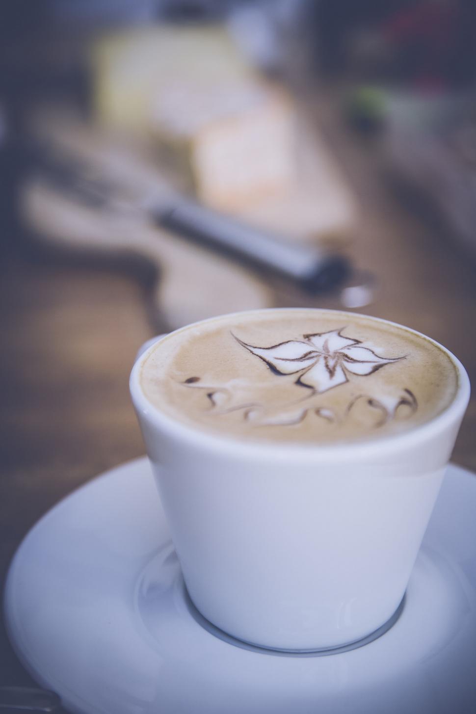Free Image of Artistic latte in a white cup on table 