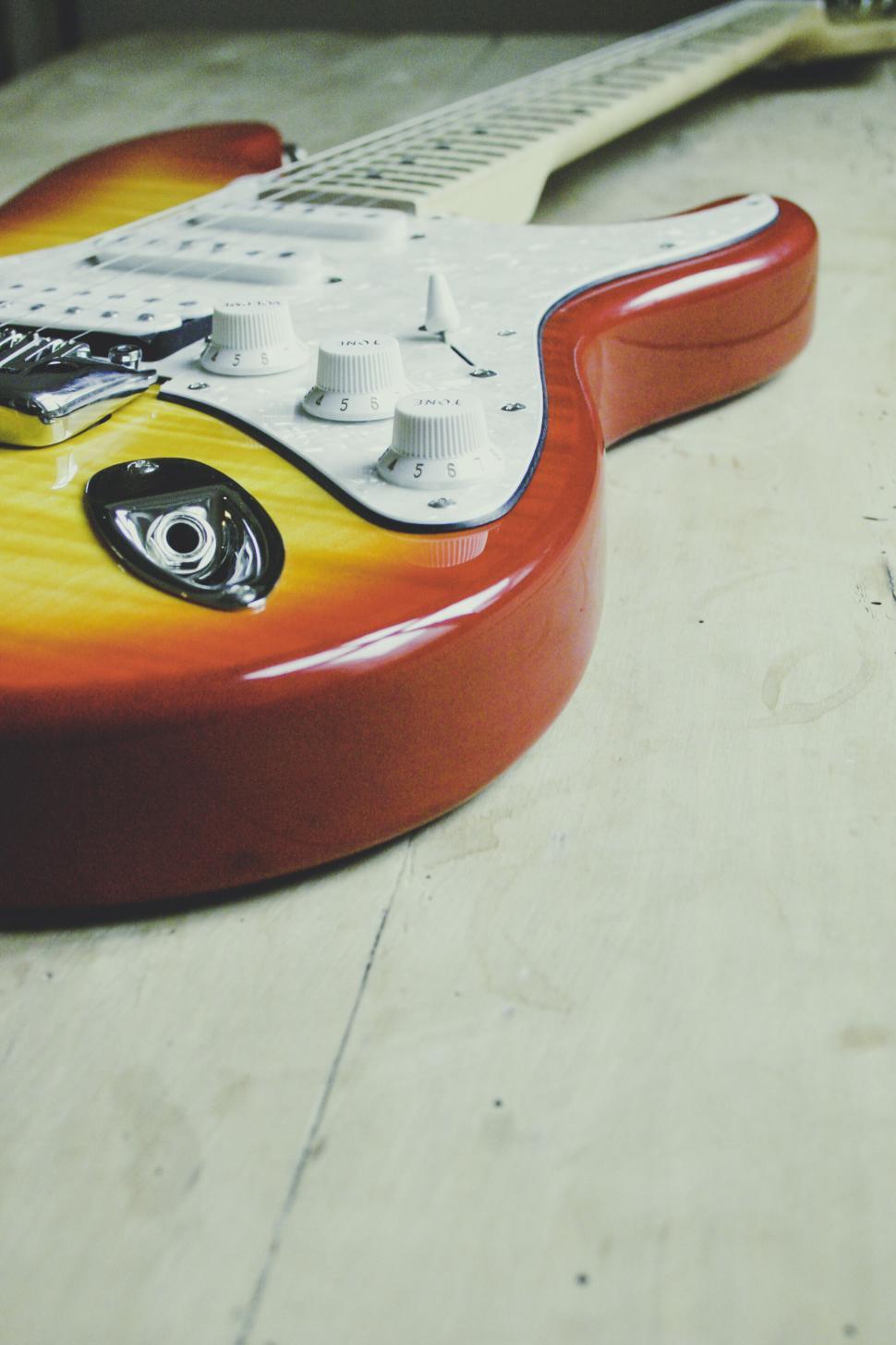 Free Image of Close-up of a red electric guitar body 