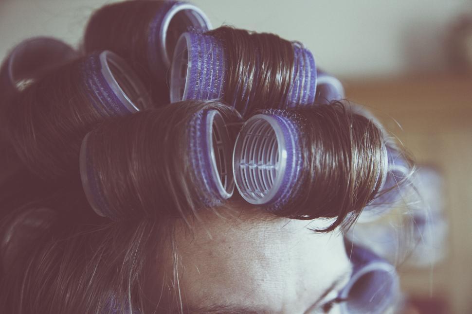 Free Image of Woman with hair rollers in natural light 