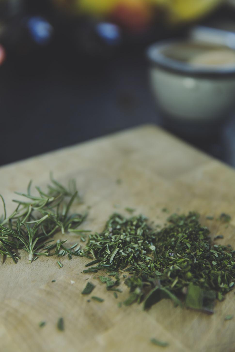 Free Image of Chopped herbs on a wooden cutting board 