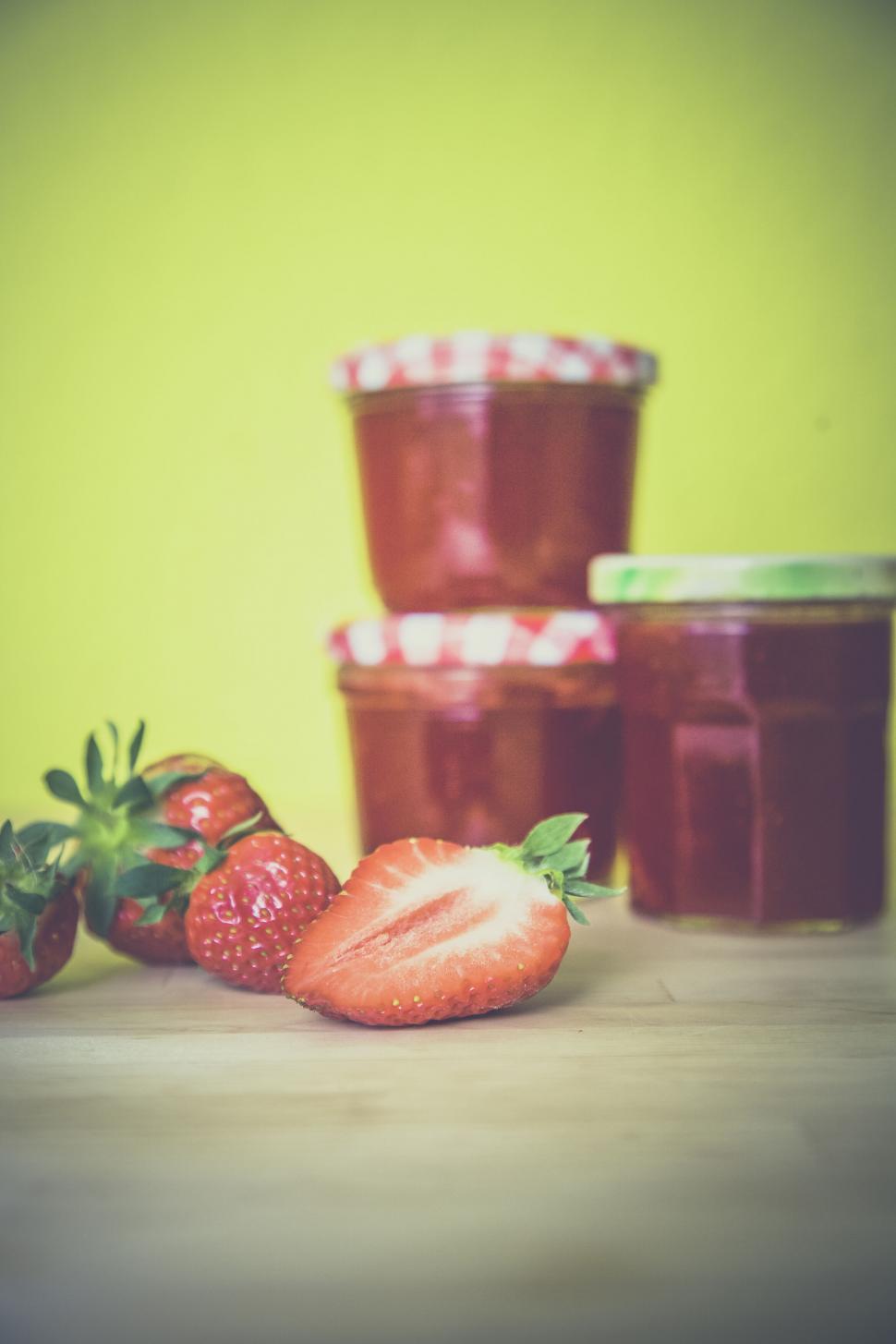 Free Image of Strawberries and jars of jam on wooden table 