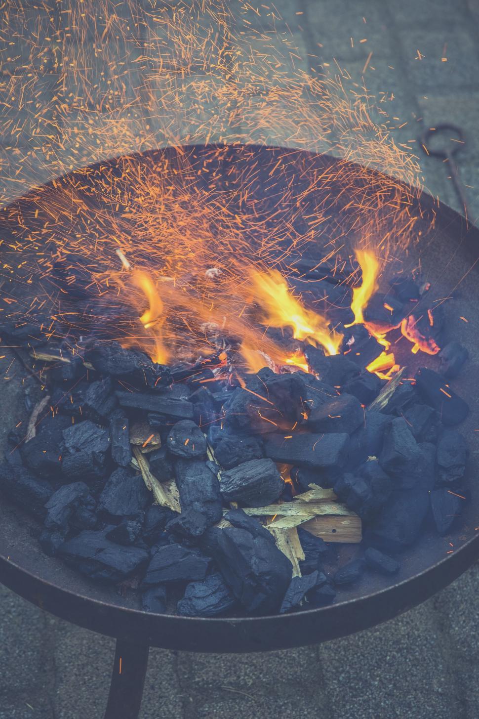 Free Image of Charcoal grill with vibrant fire sparks 