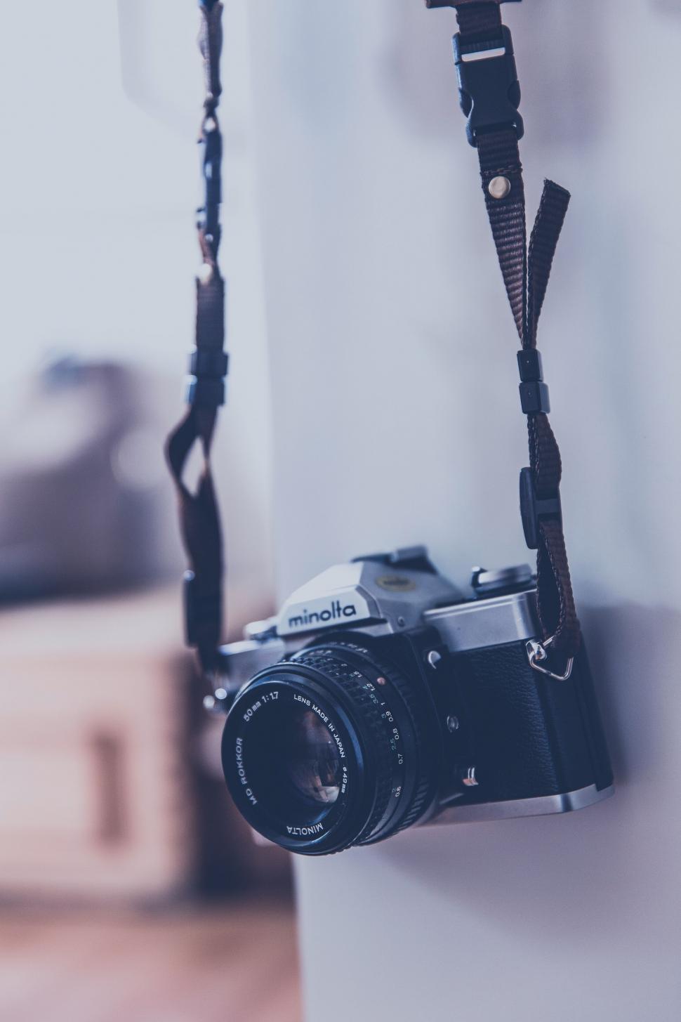 Free Image of Vintage Minolta camera hanging by its strap 