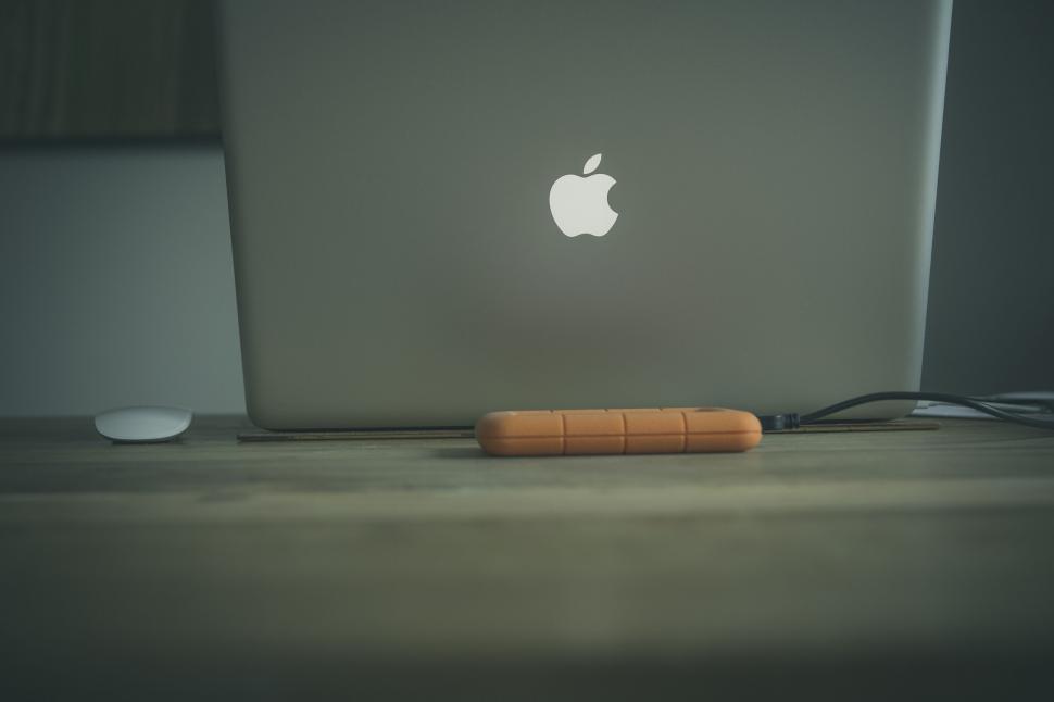 Free Image of Apple laptop with external hard drive 