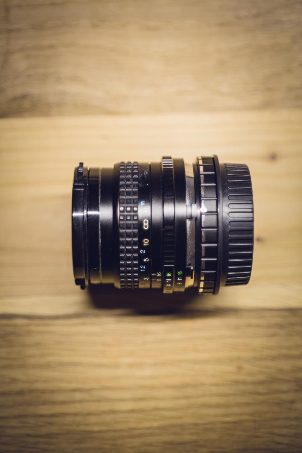 Free Image of Photography lens on wooden background 