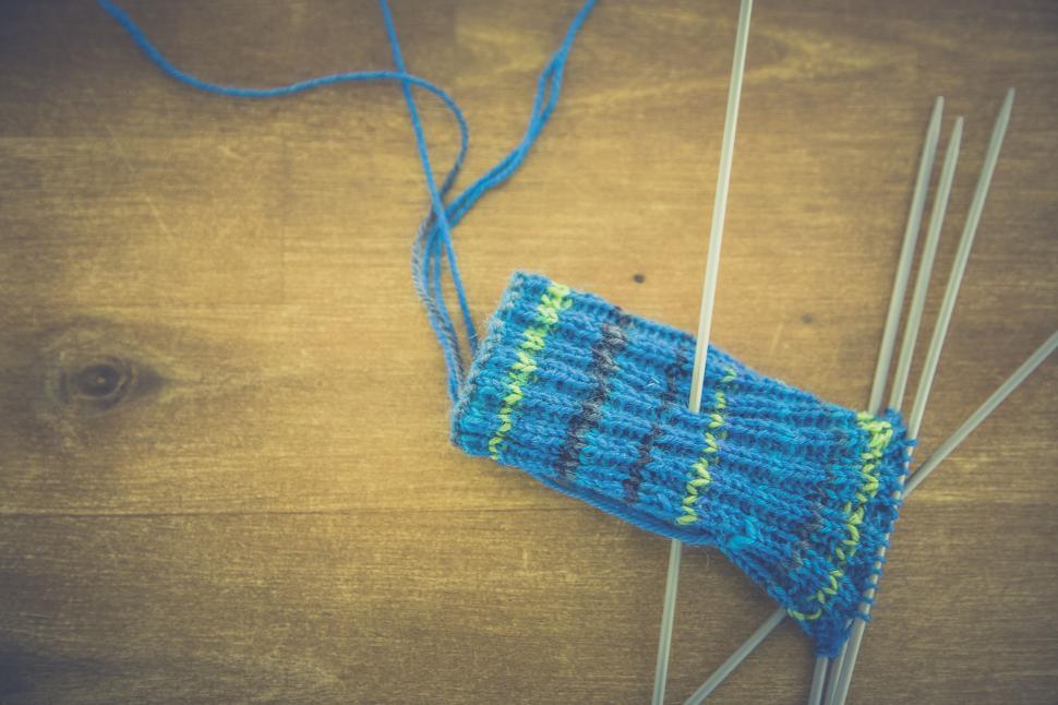 Free Image of Knitting project with needles on wood 