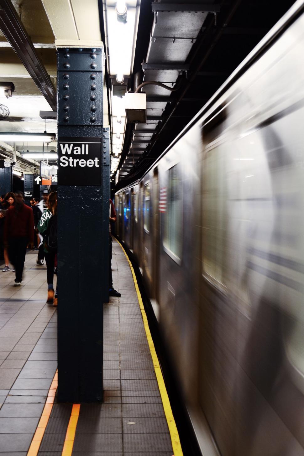 Free Image of Wall Street subway sign and passing train 