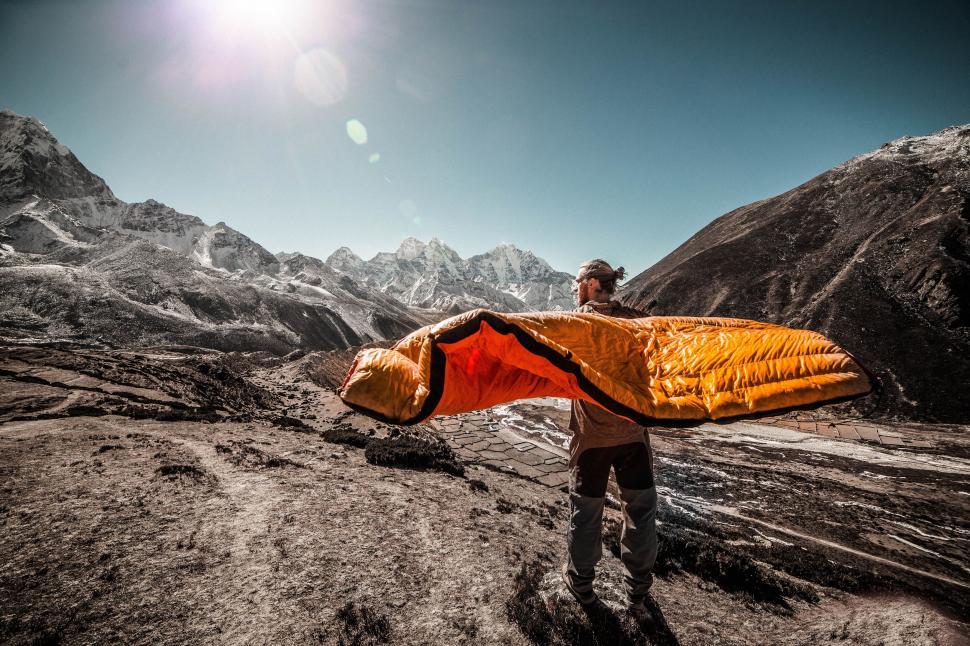 Free Image of Hiker with vibrant sleeping bag in mountains 