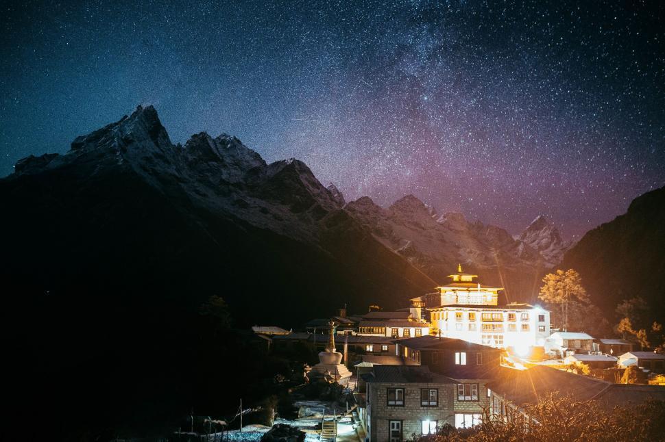 Free Image of Nighttime view of a mountainous village with stars 
