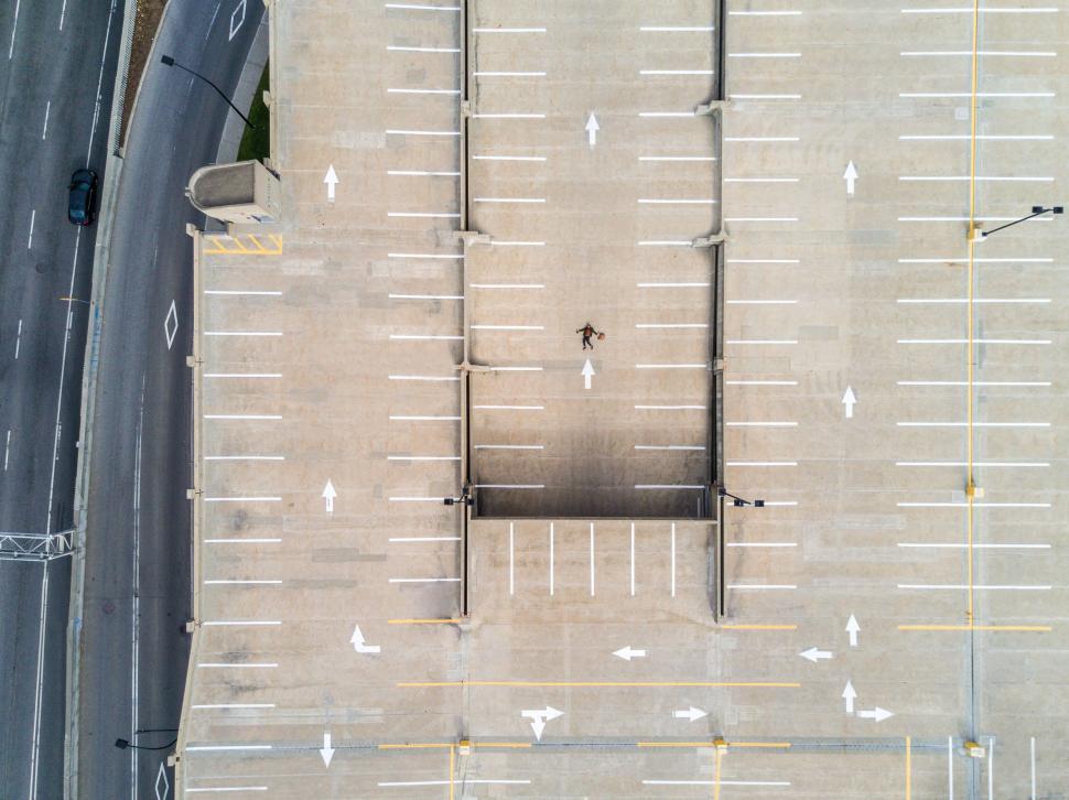 Free Image of Empty parking lot with a lone person 