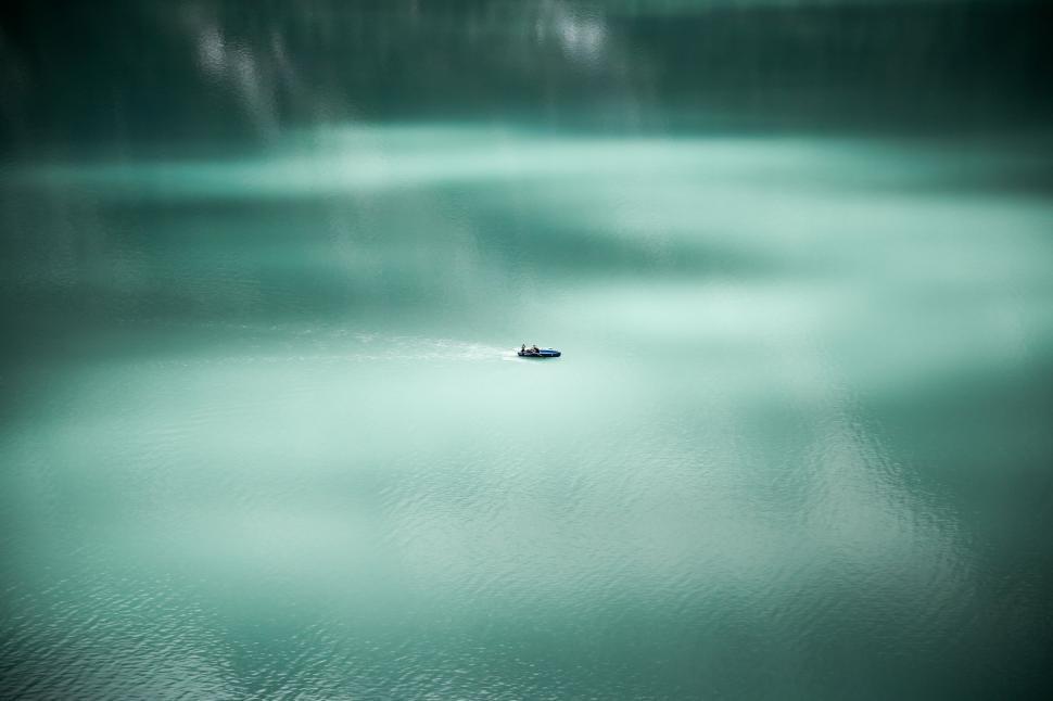 Free Image of Solitary boat on a calm turquoise lake 