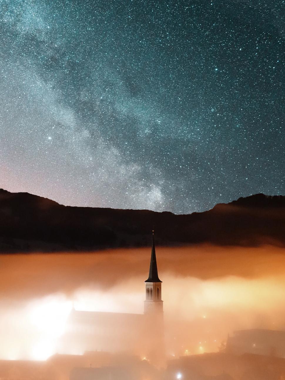 Free Image of Church spire under fog with Milky Way backdrop 