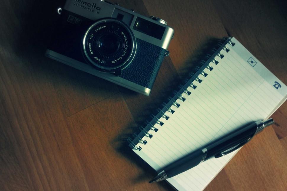 Free Image of Vintage camera beside notebook and pen 