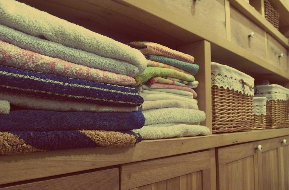 Free Image of Folded towels neatly organized in a cubby 