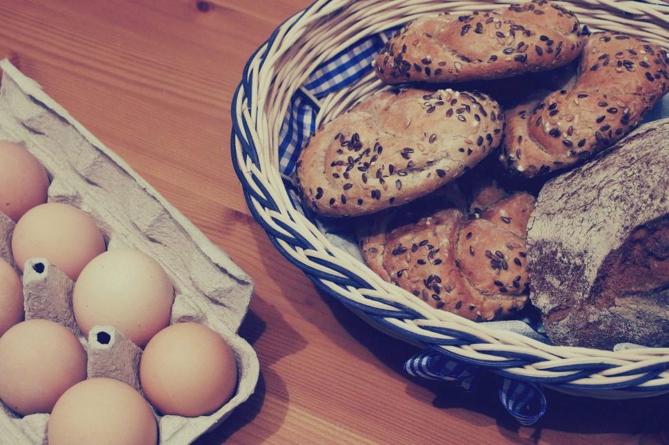 Free Image of Basket of bread and eggs on wooden table 