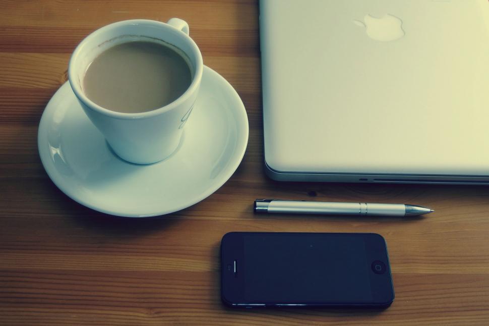 Free Image of Coffee cup beside modern gadgets on a desk 