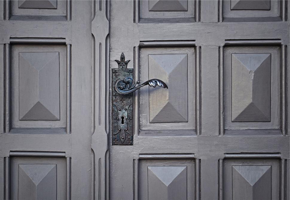 Free Image of Vintage ornate door handle on wooden door 