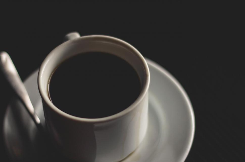 Free Image of Black coffee in white cup on dark background 