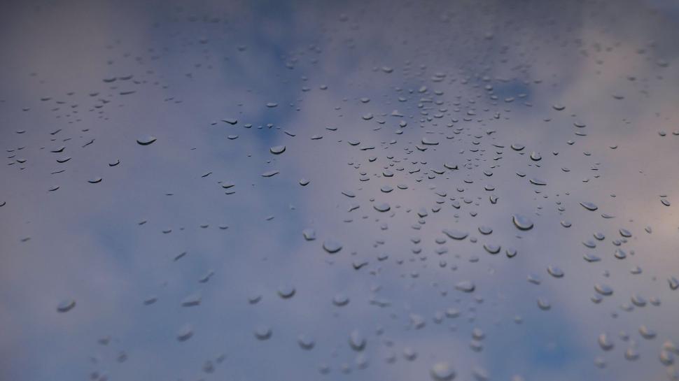 Free Image of Water droplets on a glass window surface 