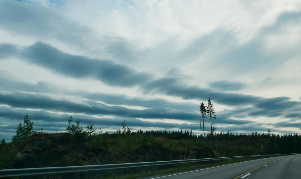 Free Image of Road with dramatic cloud formations above 