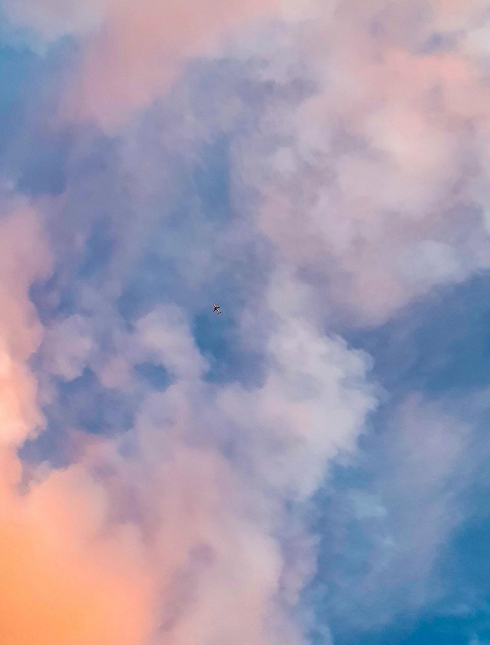 Free Image of Airplane in the sky at a colorful sunset 