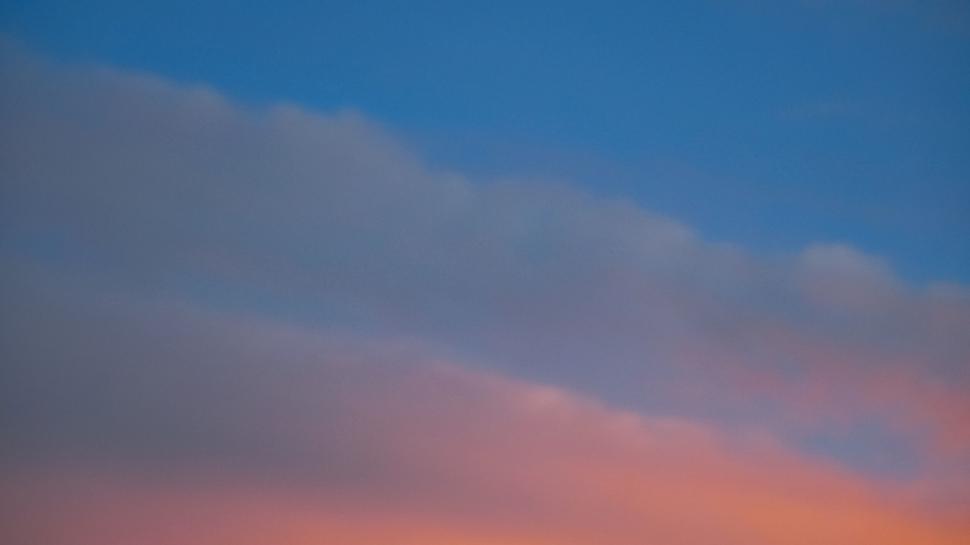 Free Image of Clouds painted in twilight hues over sky 