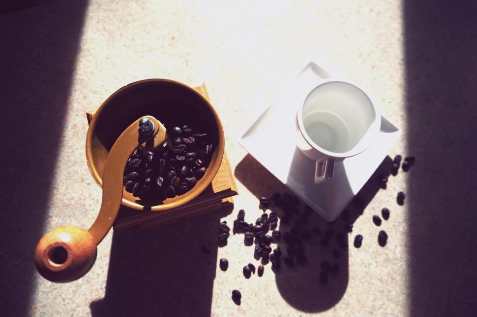 Free Image of Coffee grinder and cup in morning light 