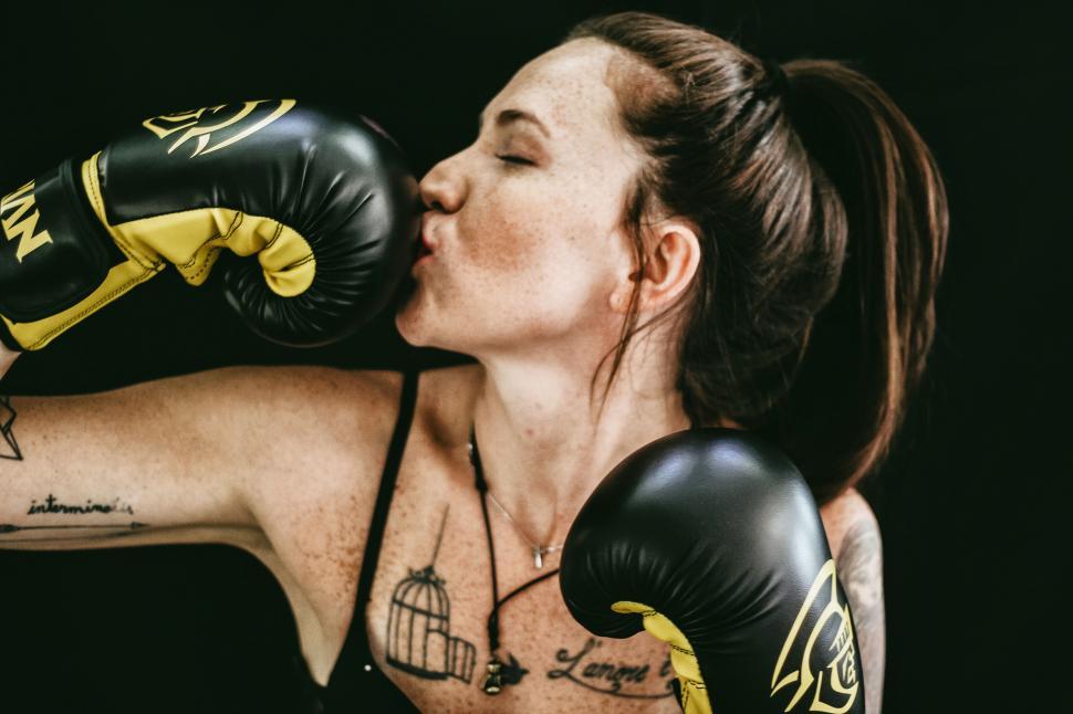 Free Image of Female boxer with yellow gloves posing 