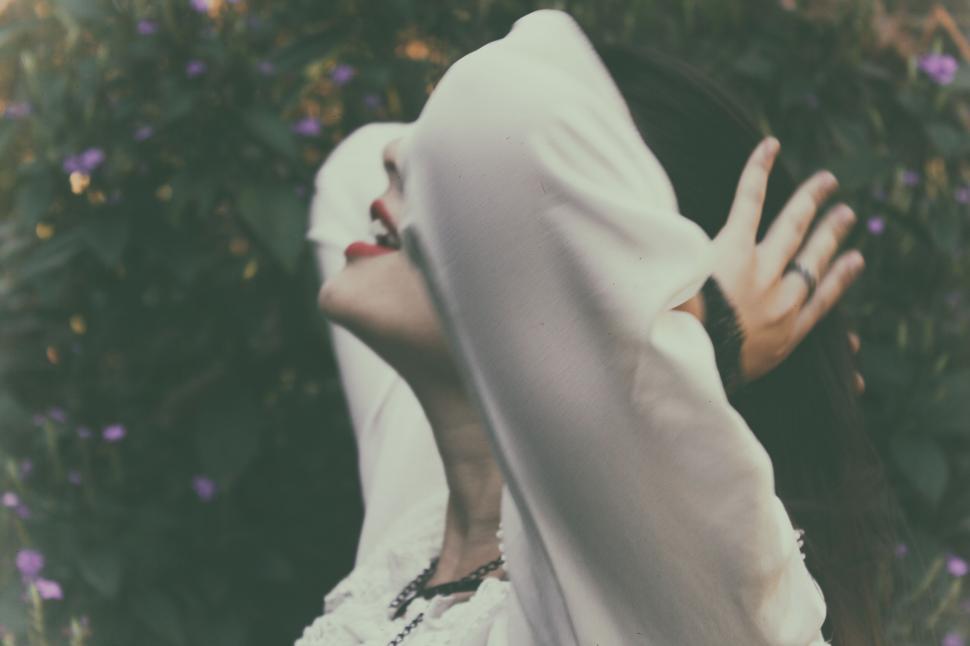 Free Image of Woman with white veil over her face in nature 