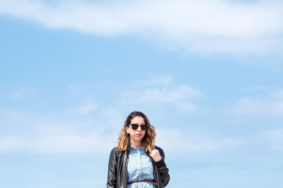 Free Image of Young woman against clear sky looking cool 