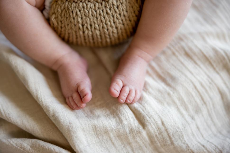 Free Image of Closeup of baby feet and knitted basket 